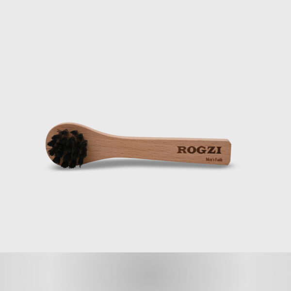 "Steam wood handle shoe cleaner brush placed horizontally, with the focus on its bristles. The grey background enhances the texture and detail of the brush's bristles."