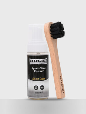 A foaming shoe cleaner with a brush is centered in the image, showcasing the cleaning product and tool together for easy use.