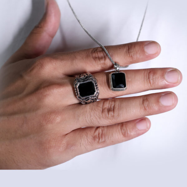 "Bold elegance: Showcasing a striking silver-colored ring and pendant adorned with rich black stones."