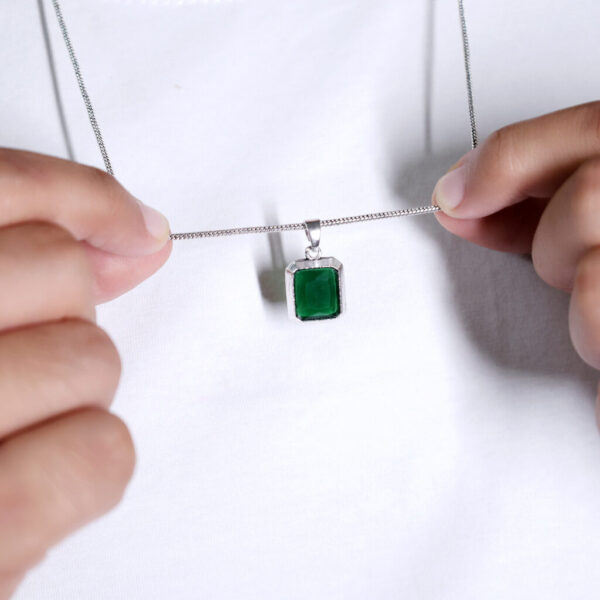 Embrace the vibrant energy of this green stone pendant, a symbol of growth and renewal.