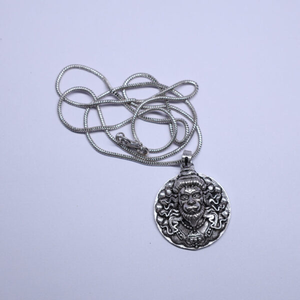 "Hanuman Ji pendant with a chain, displayed against a white background. The pendant features intricate details of Hanuman Ji, and the chain complements the design, both highlighted by the clean, white backdrop."