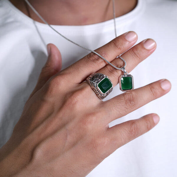 "Elegant green gemstone jewelry with a silver-colored finish."